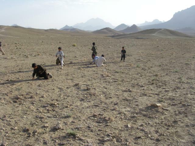 Afghan kids picking up brass